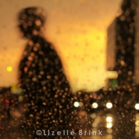 Man crossing road in rain