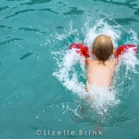 Child jumping into pool